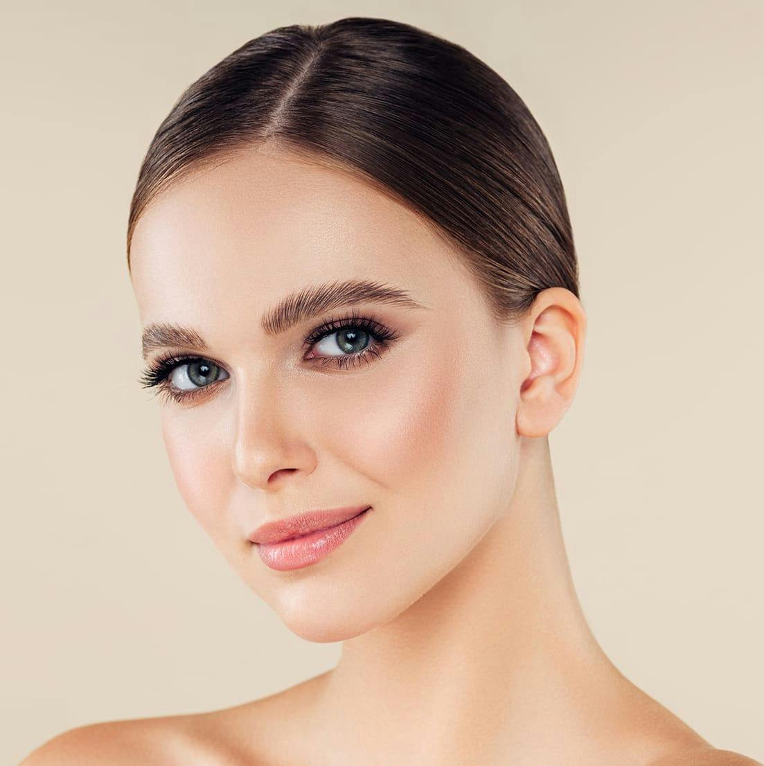 woman with brown hair slightly smiling