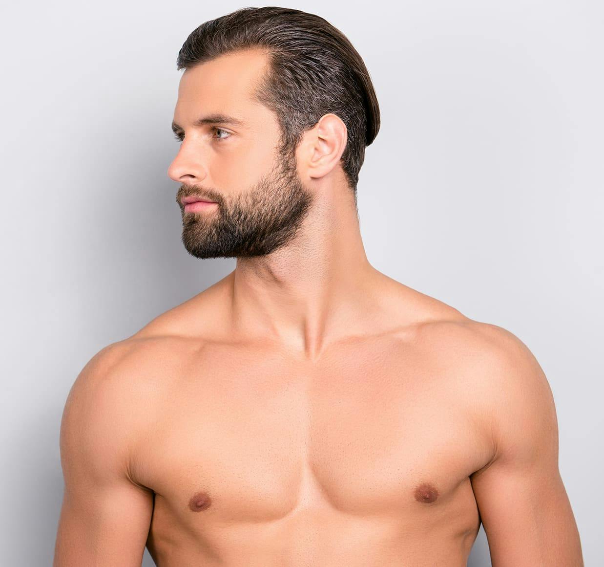 man with a beard and no shirt on posing for a picture