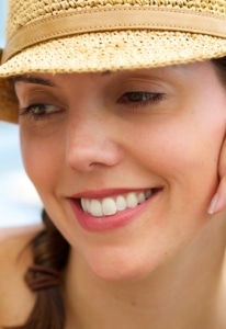 woman smiling with a hat on