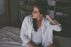 woman sitting on a bed