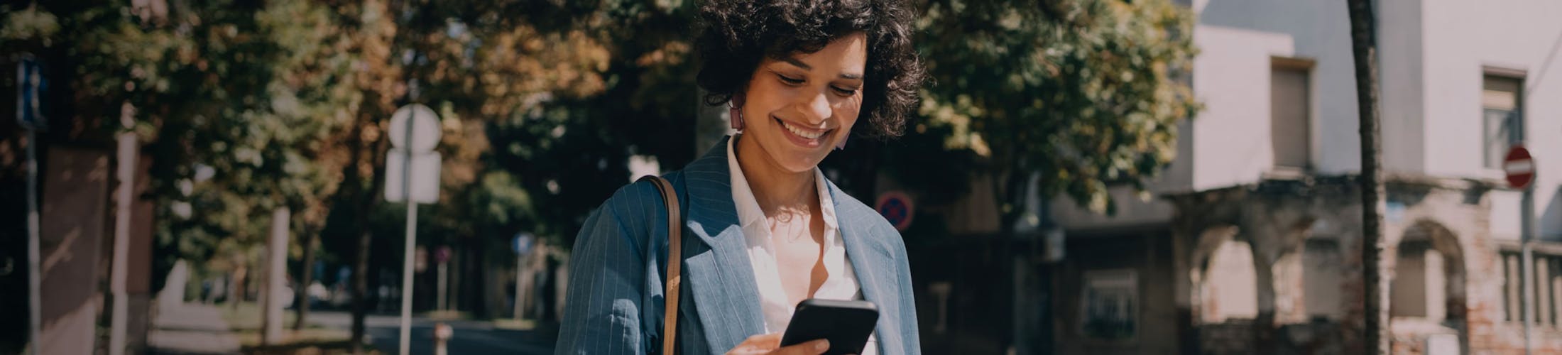 there is a woman that is looking at her cell phone