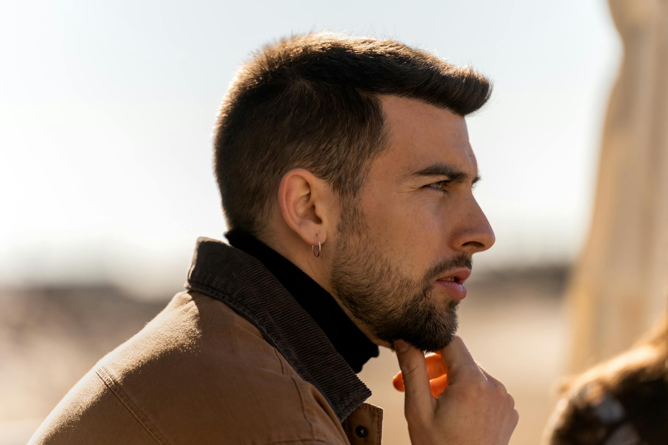 man touching his chin thinking