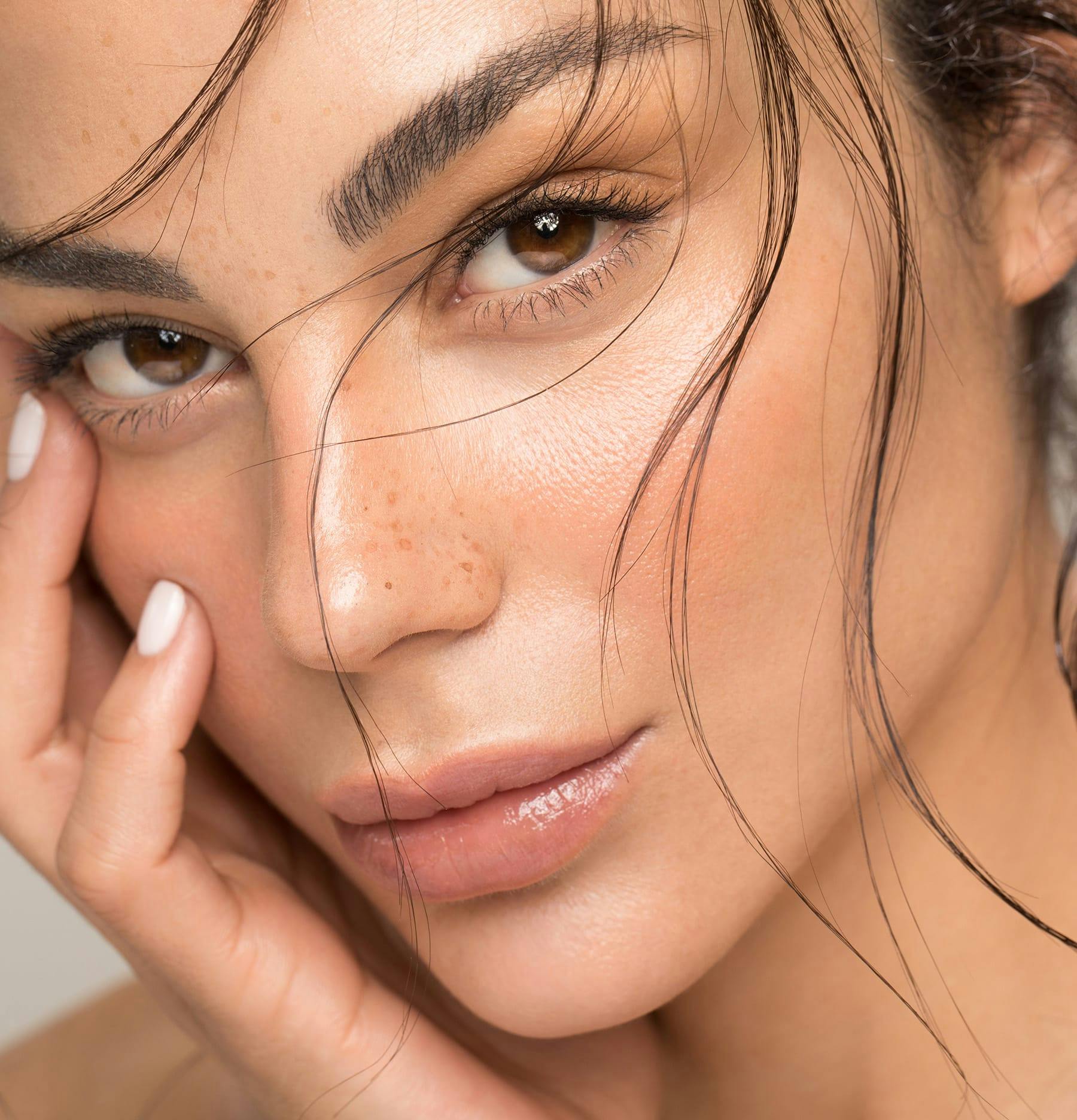 Woman with brown eyes and freckles on her nose