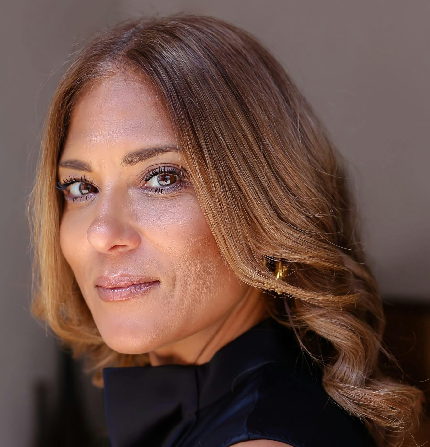 Woman with curly hair smirking