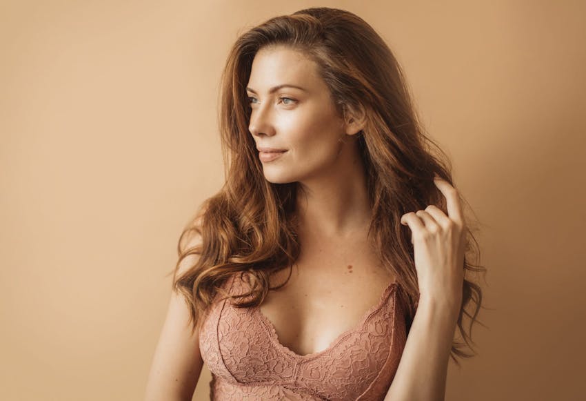 Woman wearing a peach lacy bra