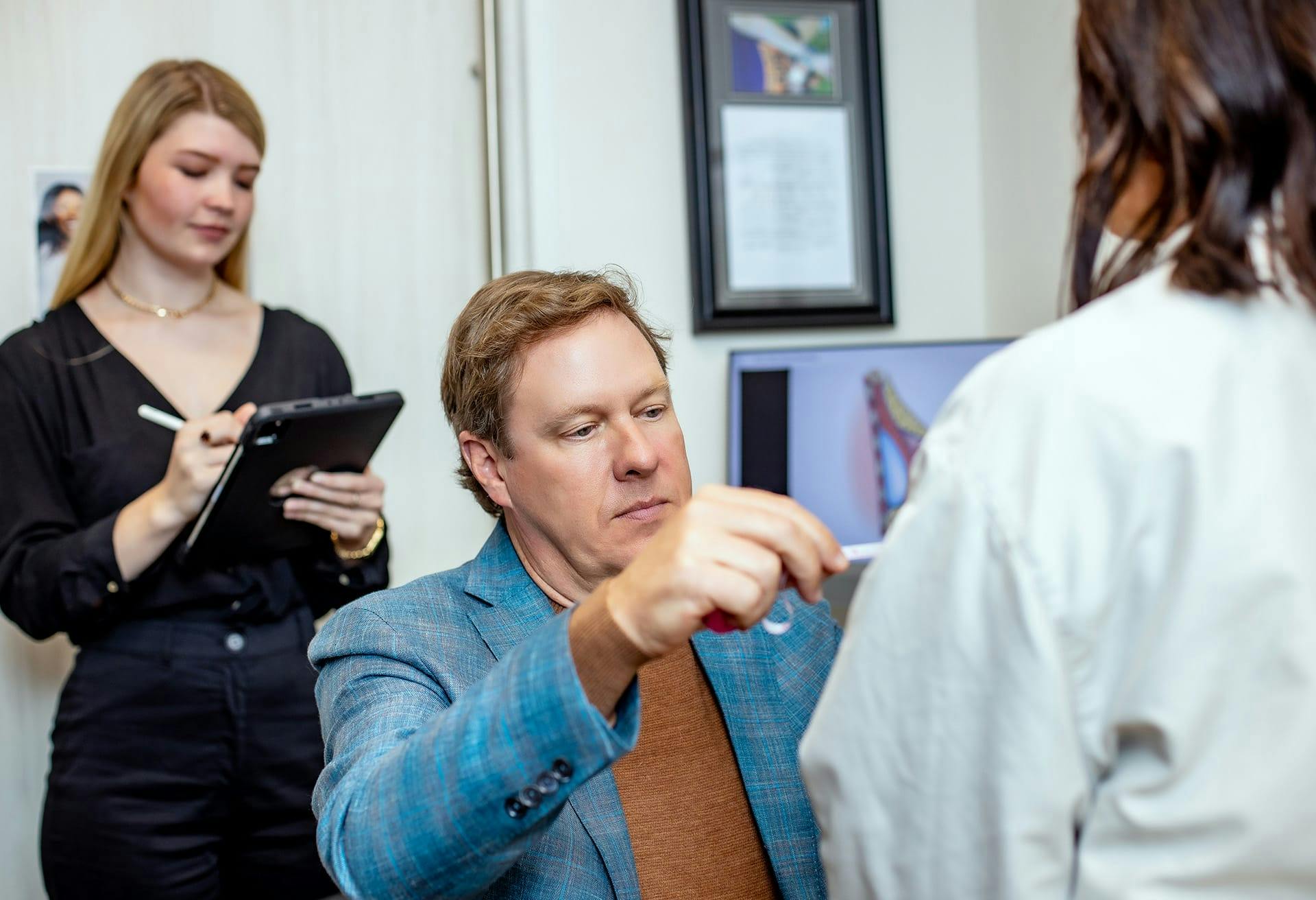 Doctor inspecting a female patients chest area
