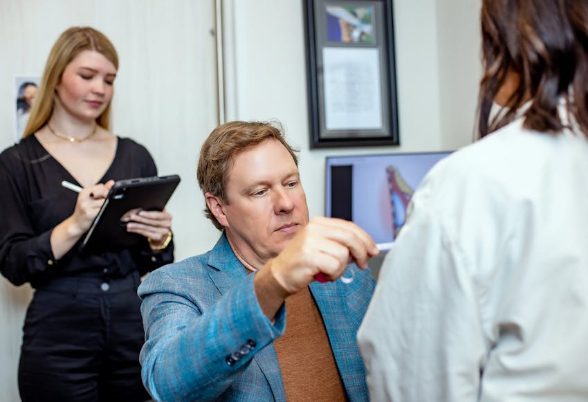 Doctor inspecting a female patients chest area