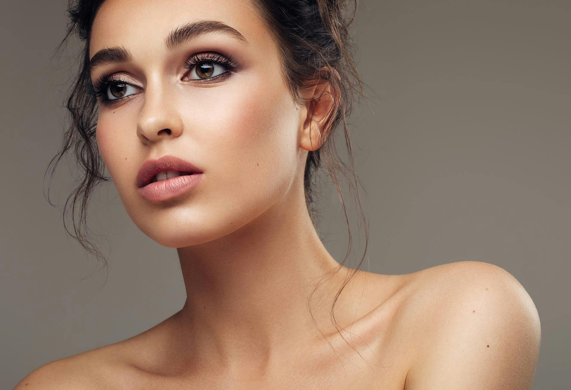 Beautiful woman with her hair in an updo, looking to the side
