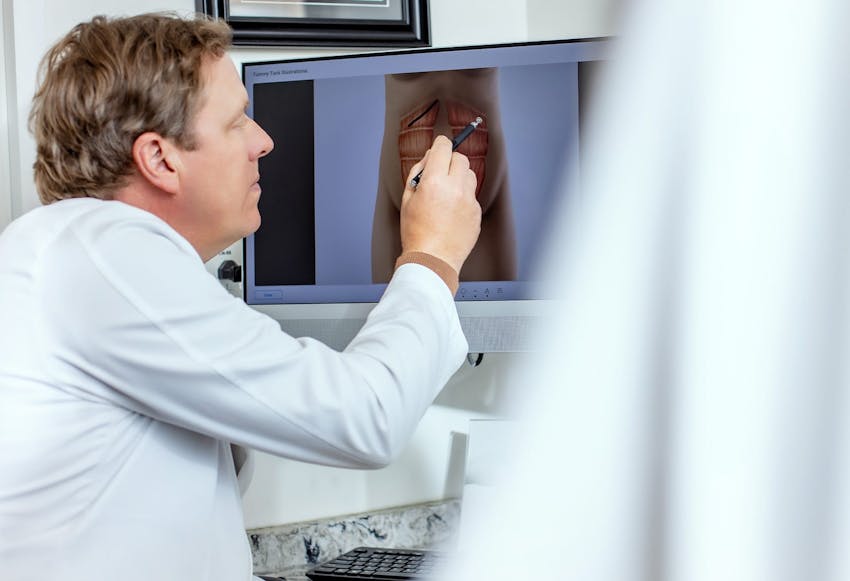 Dr. Pointing at a Computer Screen