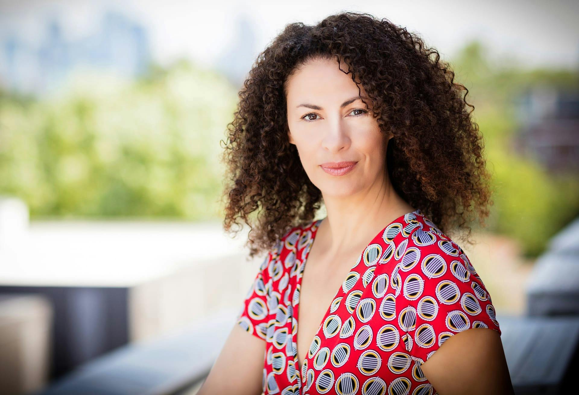 Woman with Dark Curly Hair and Red Shirt