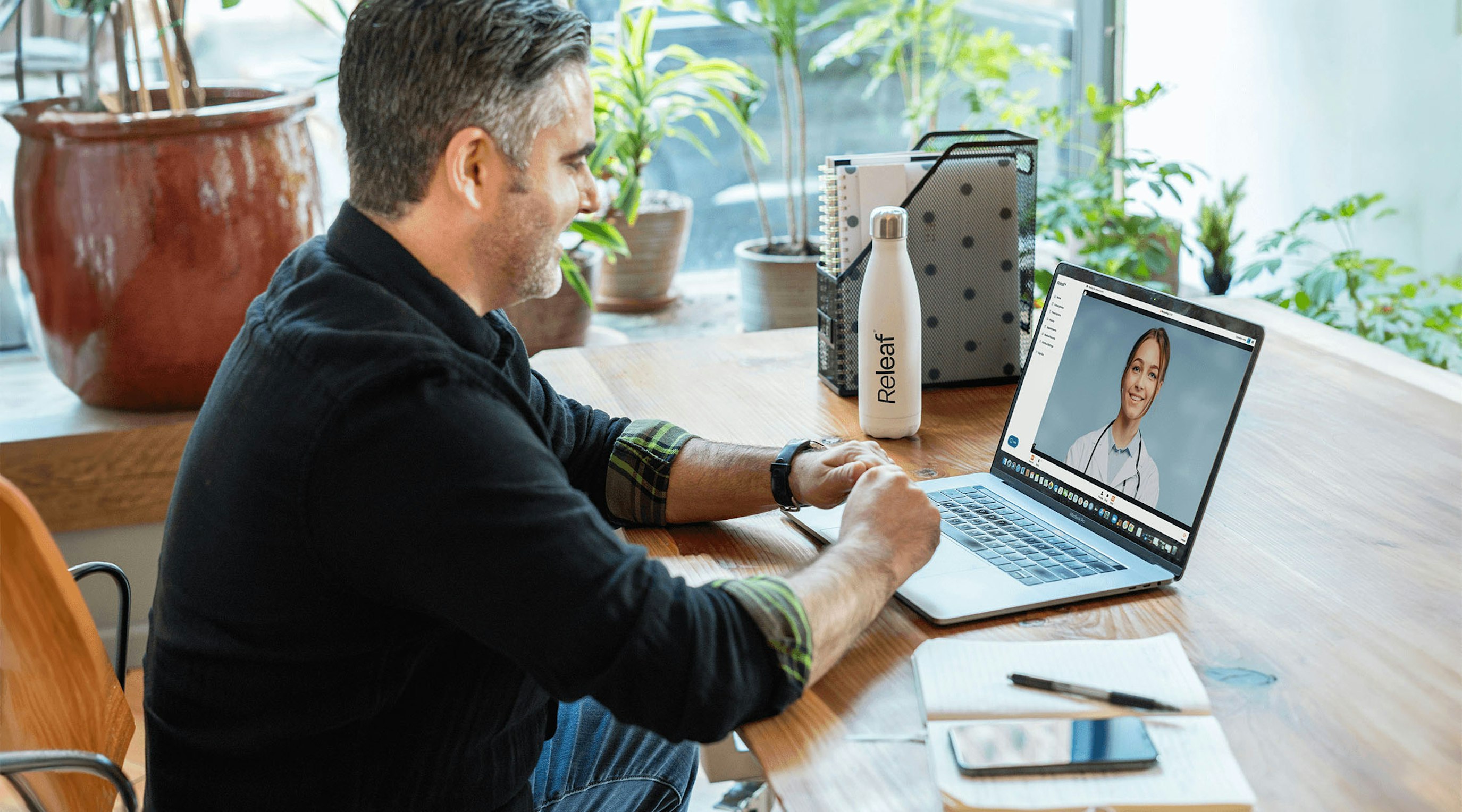 Doctor examining a bottle of medical cannabis for patient treatment