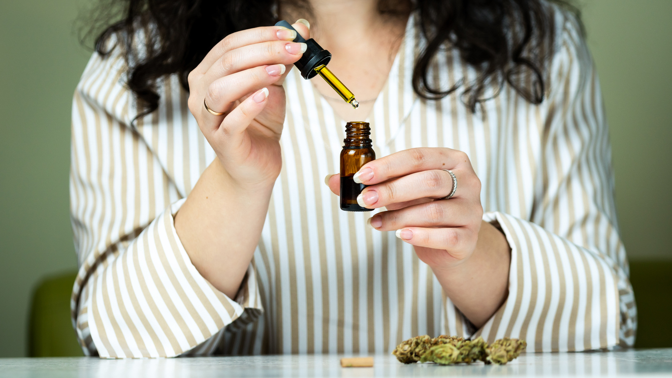 Woman Using Medical Cannabis Oil and Flower