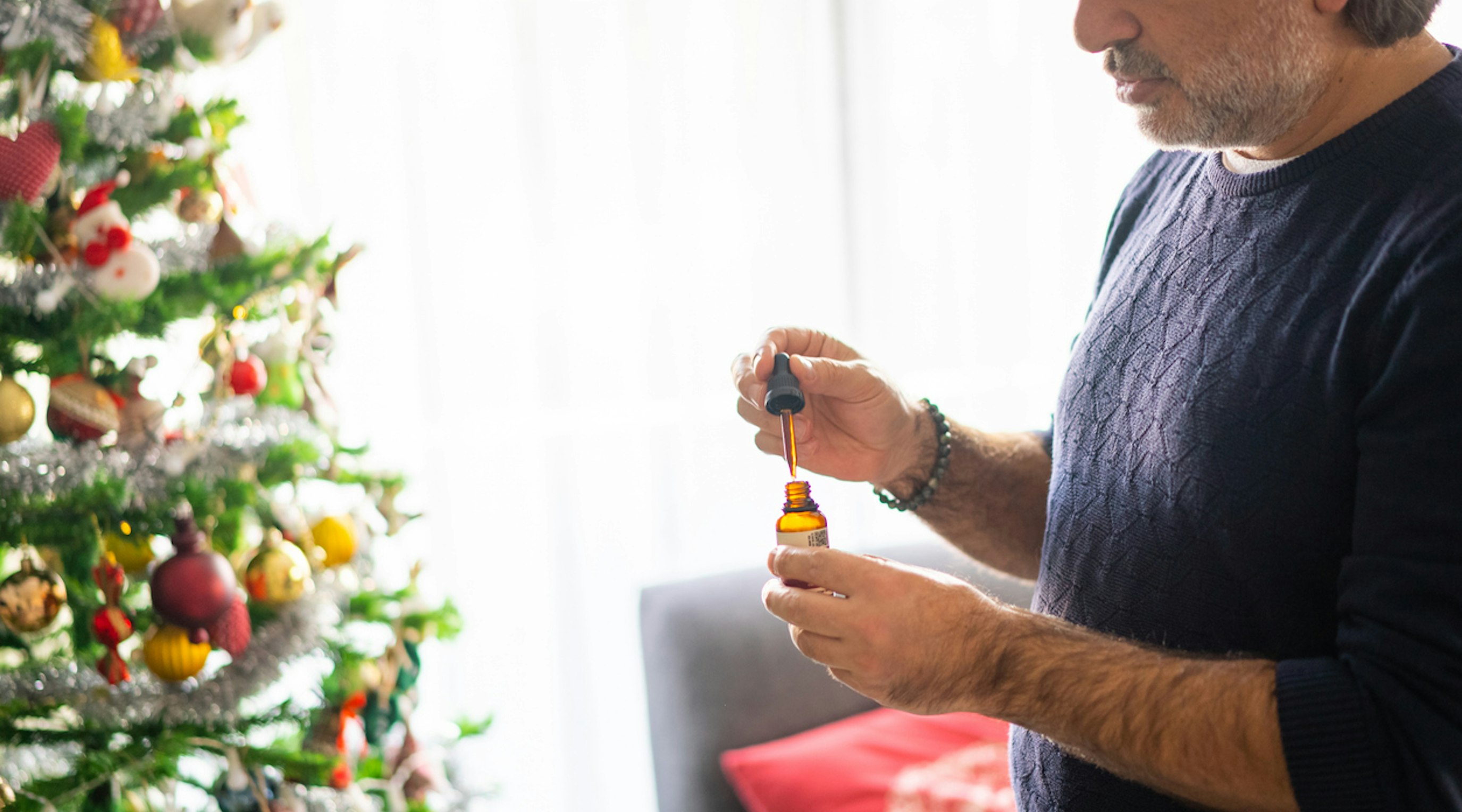 Man with Cannabis Oil During Christmas Man with Cannabis Oil During Christmas