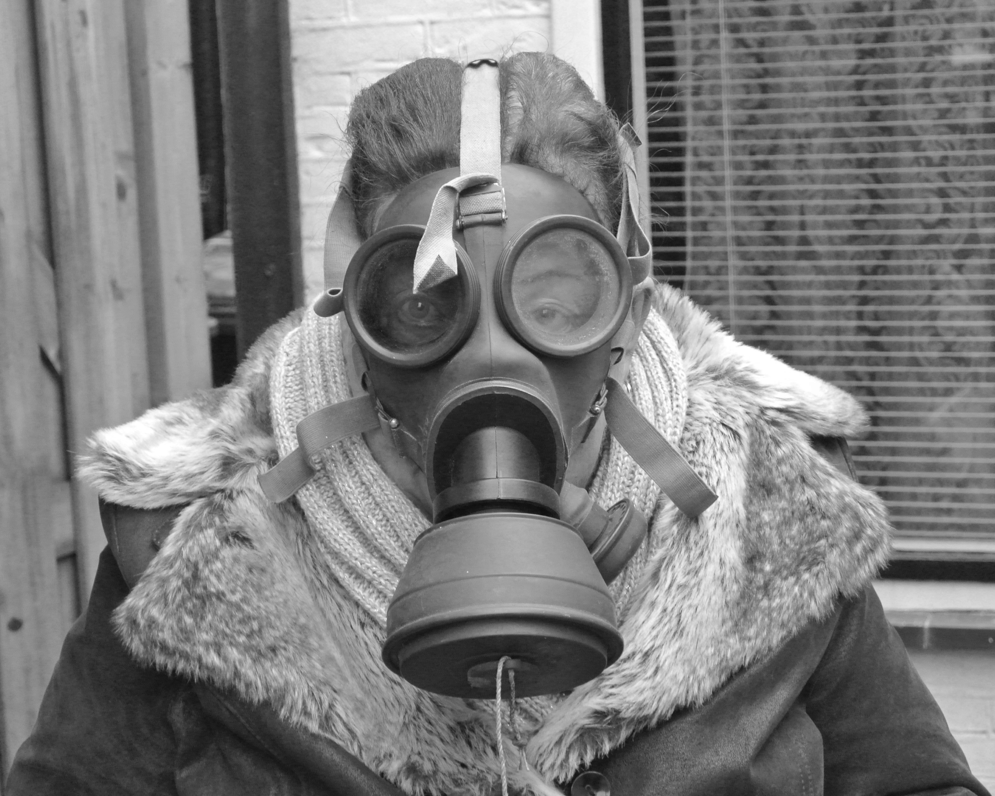 Photo series on war, grandma wearing a world war two gas mask.