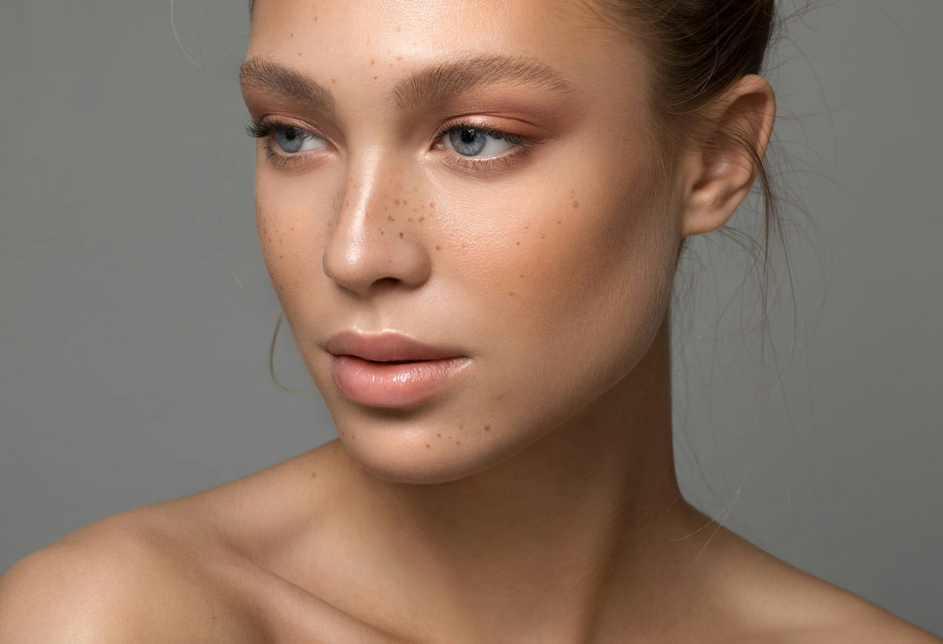 Woman with Freckles and Bare Shoulders