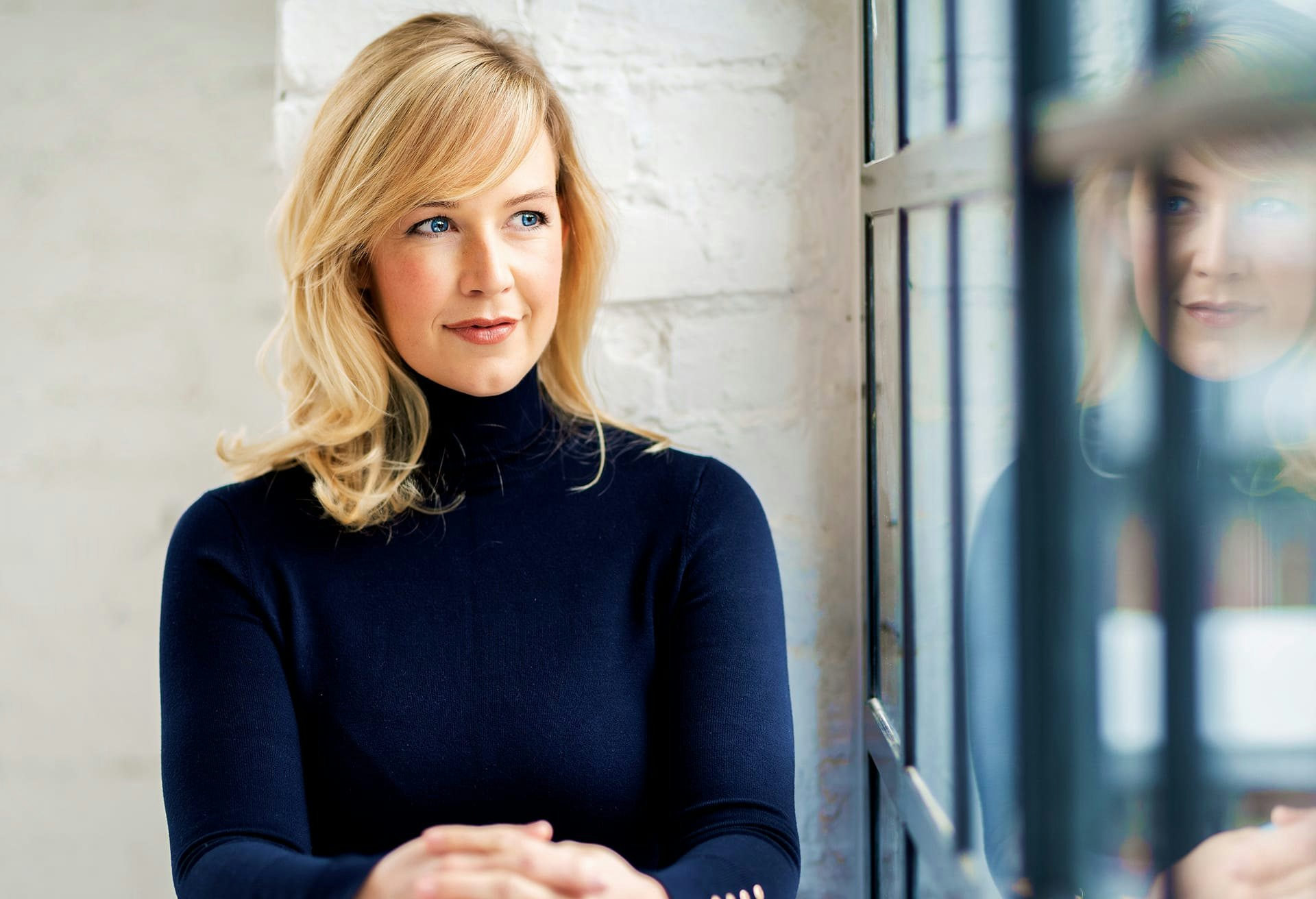 Woman with Blonde Hair and a White Turtleneck