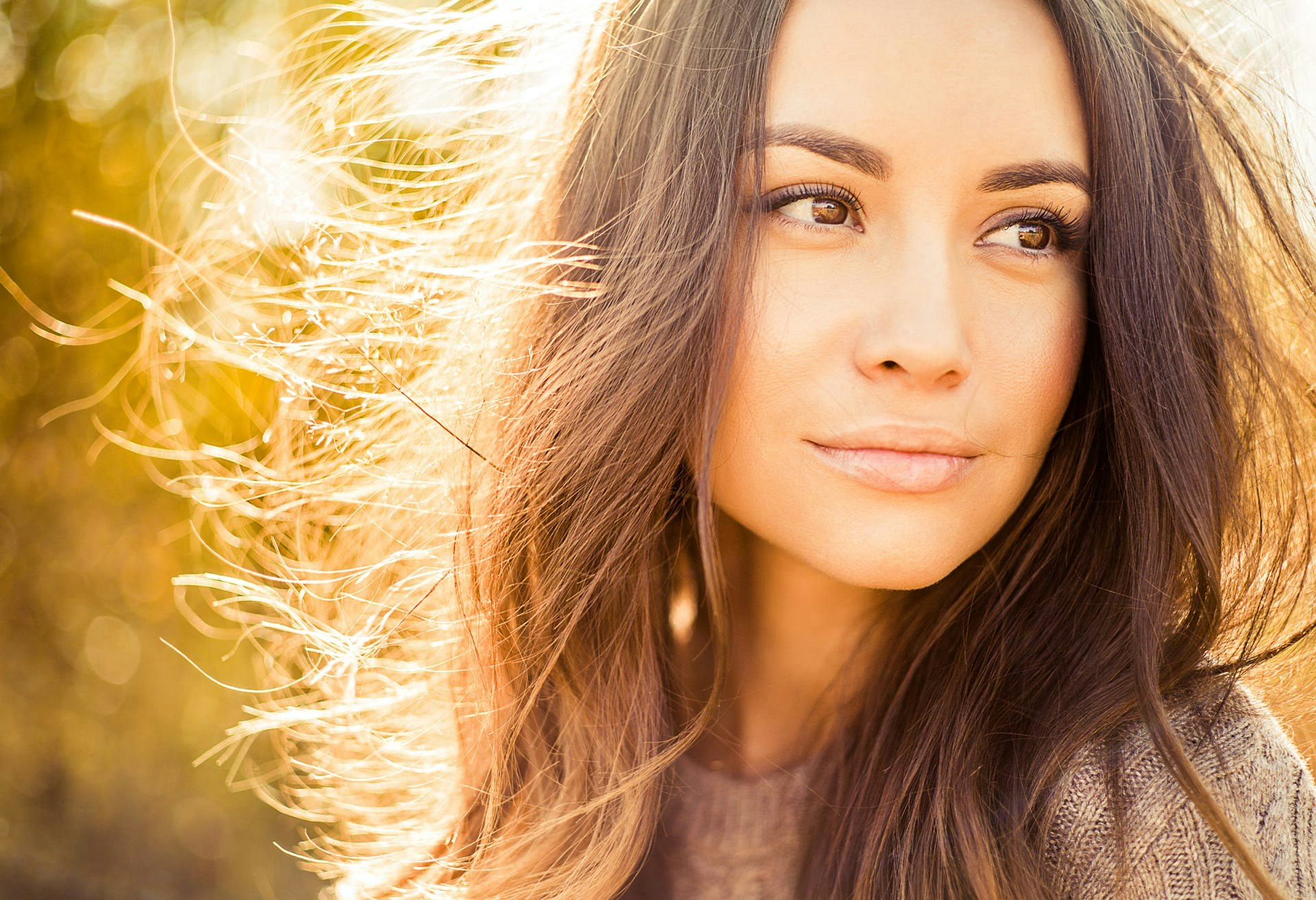 Woman with Sun Shining Behind Her