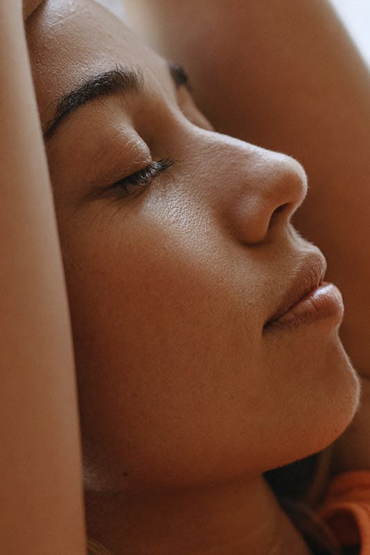 Very close up shot of woman with her eyes close.