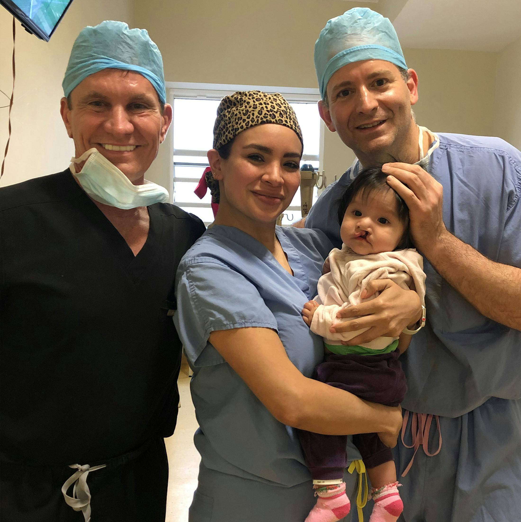 Dr. Shapiro and His Team Holding a Baby