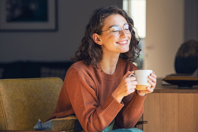 Happy woman drinking coffee