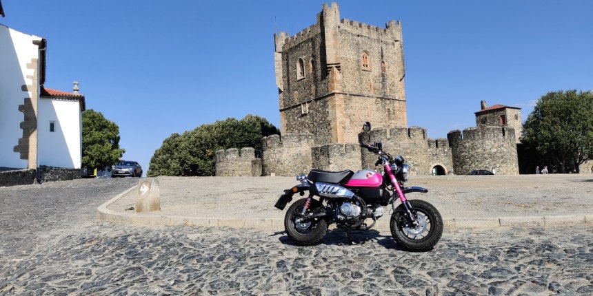 Pink motorcycle in front of the magnificent medieval castle of Bragança
