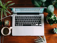 Laptop surrounded by plants