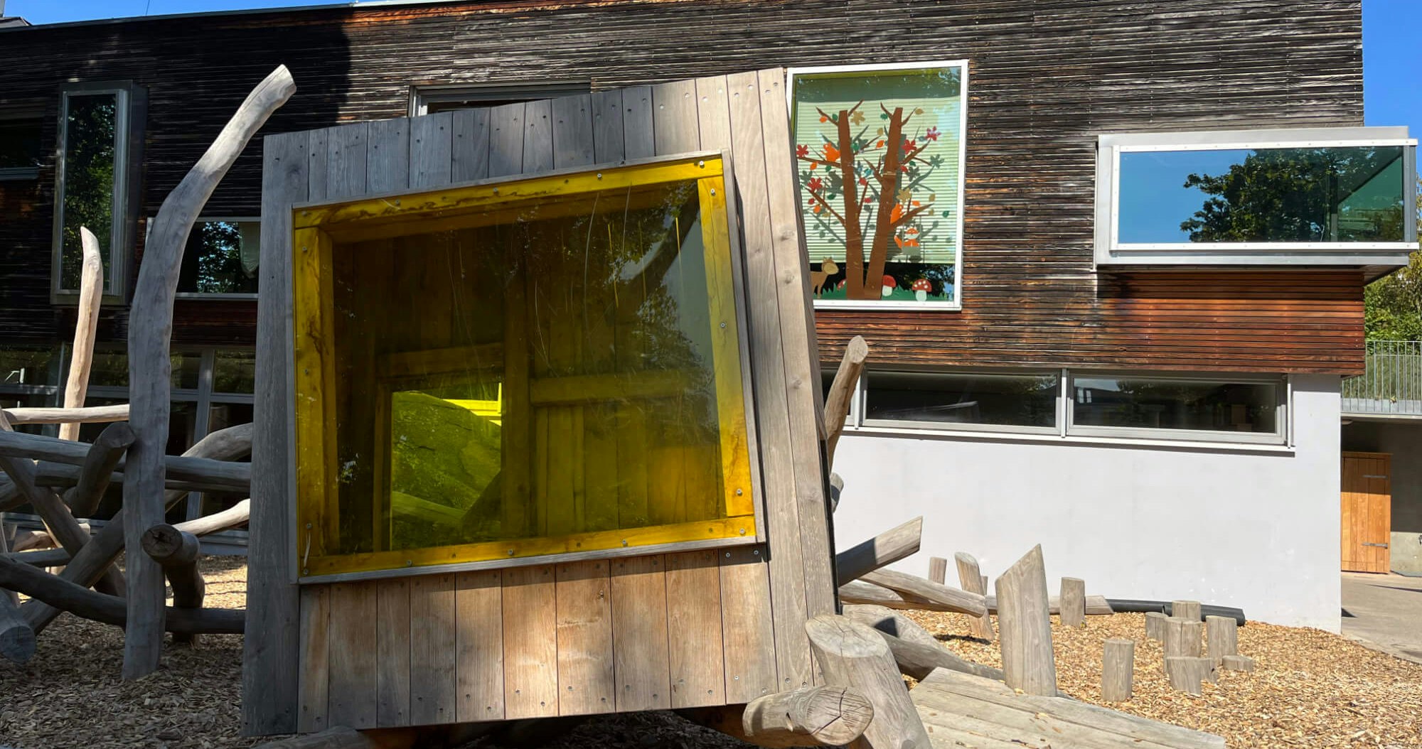Eine Holzkonstruktion mit einem gelben Fenster.
