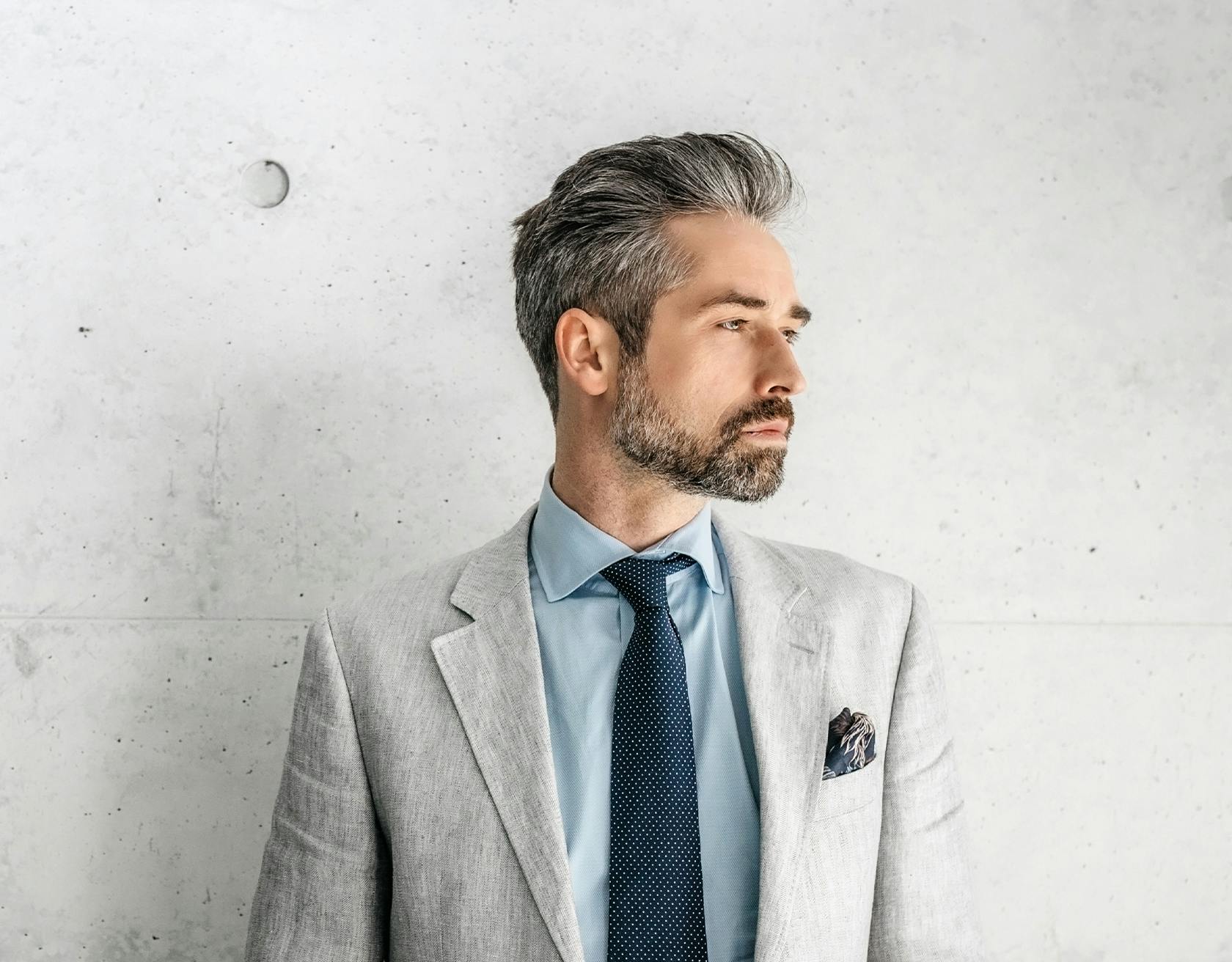 Man Posing in Front of a Wall