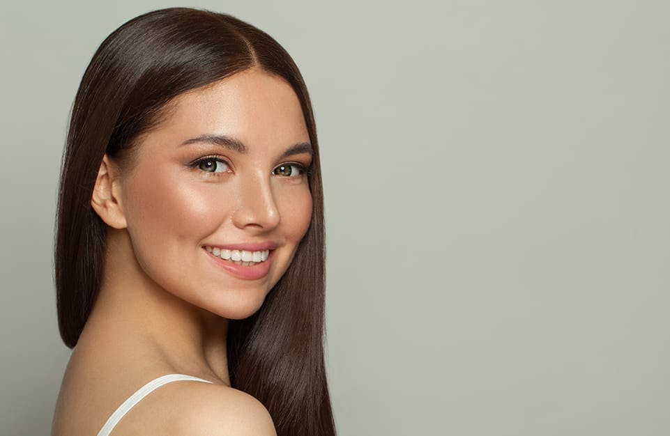 Woman Smiling and Looking at the Camera