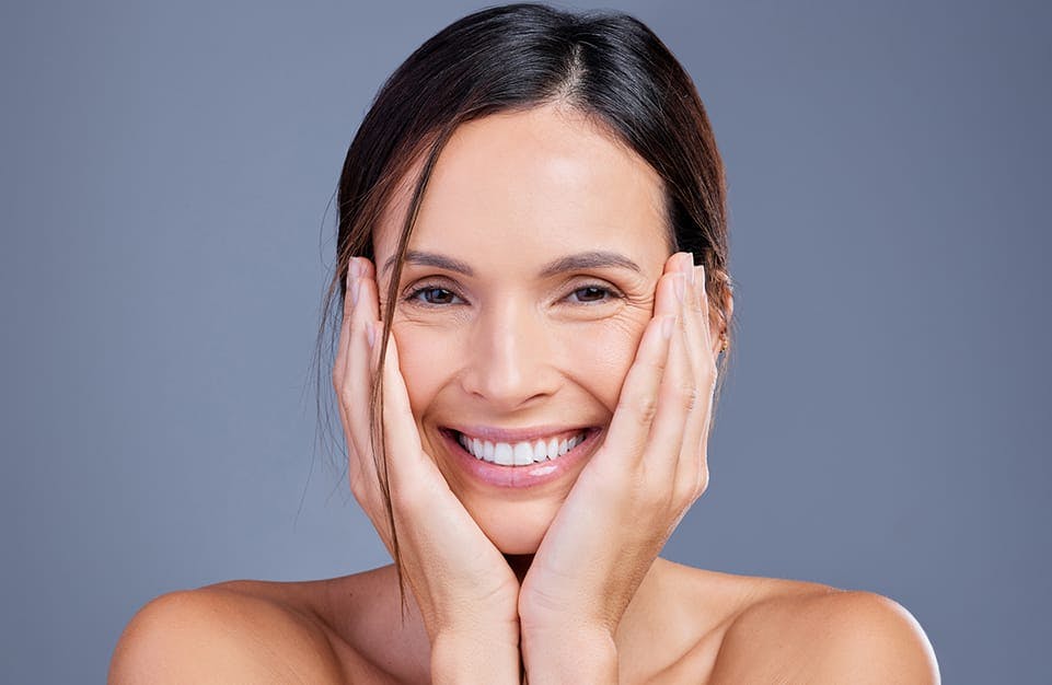 Smiling Woman with Hands Cupping Her Face