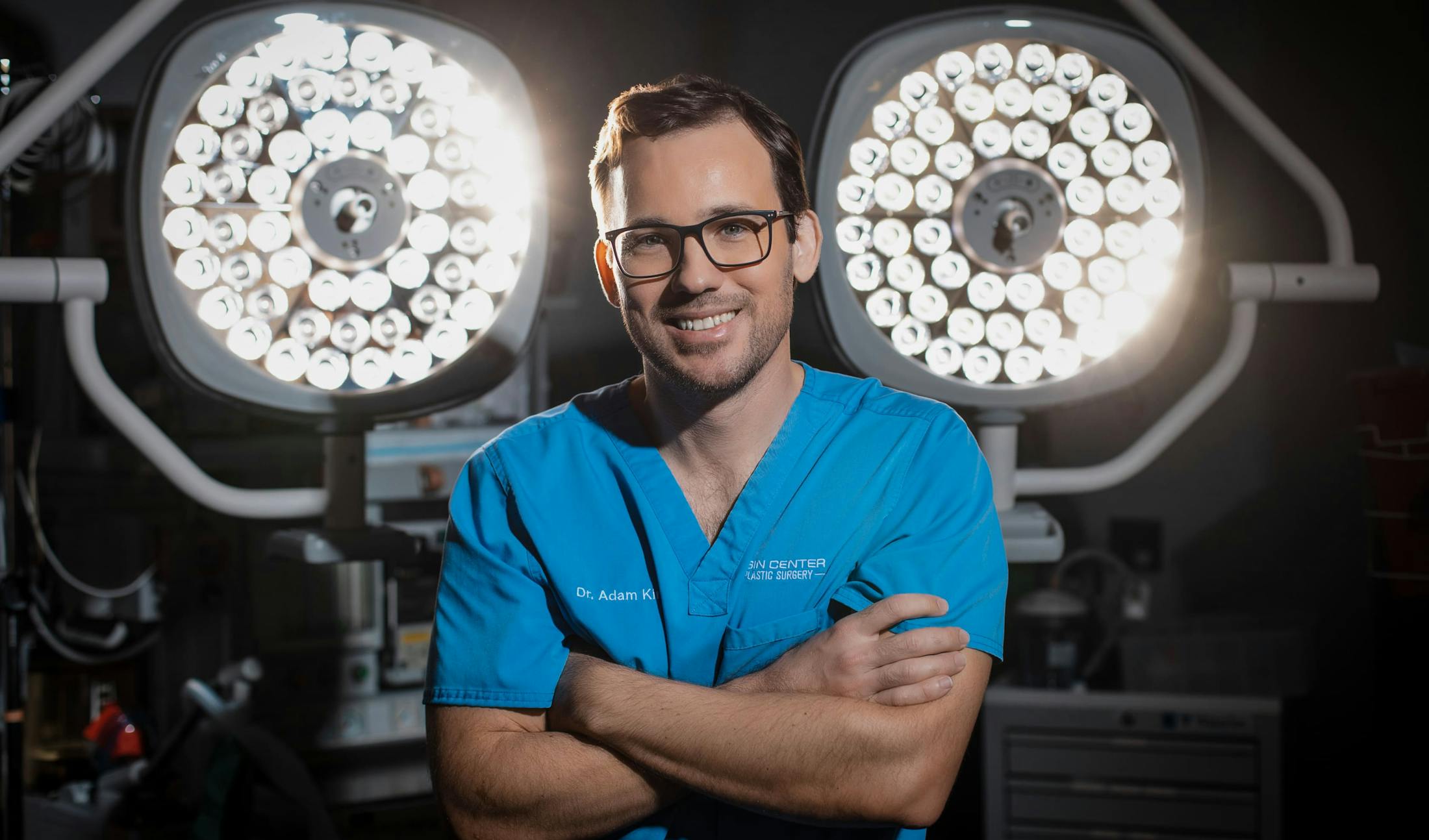 Dr. Kinal  smiling in surgery garb