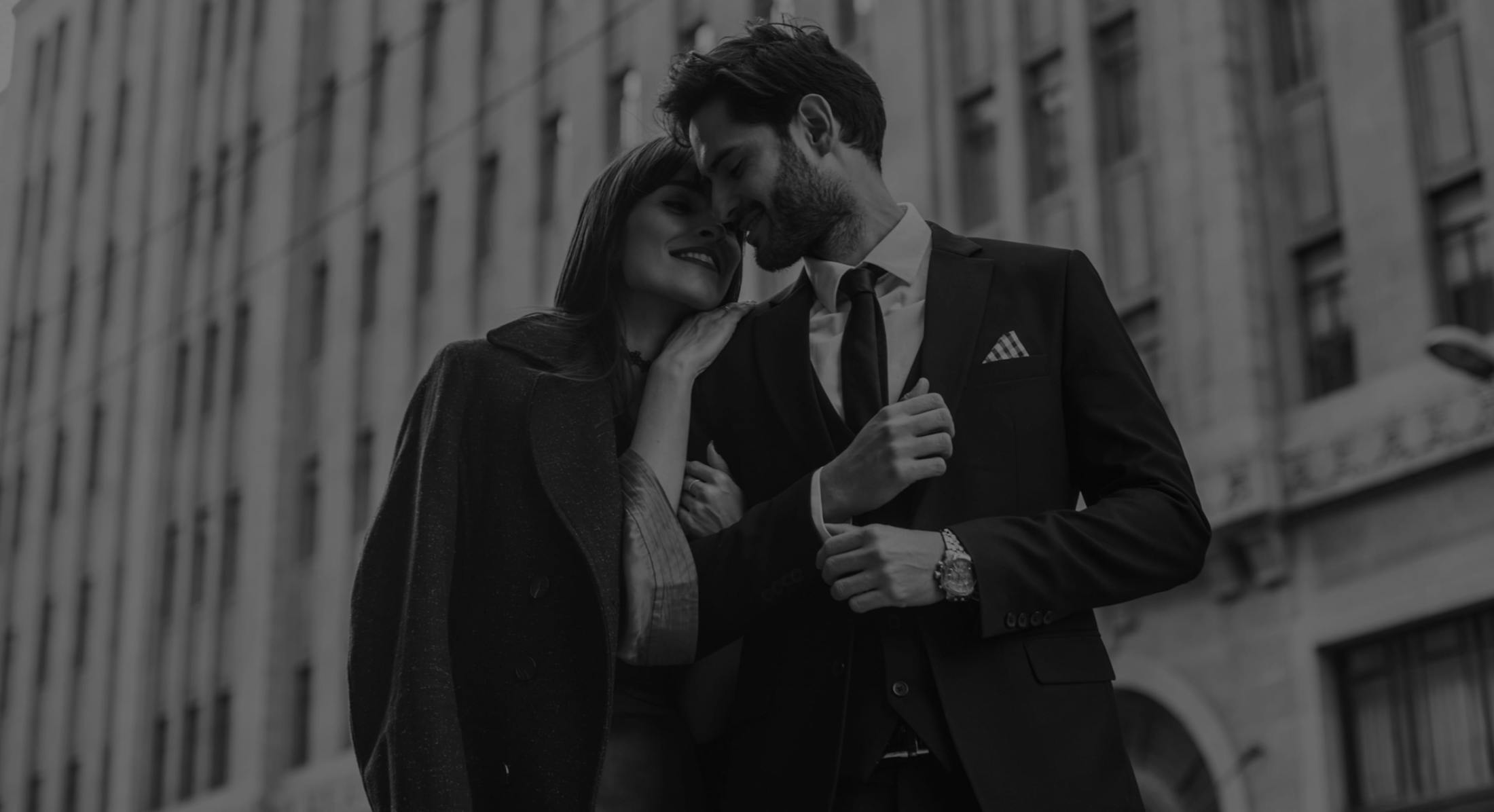 Man and woman smiling and leaning on each other