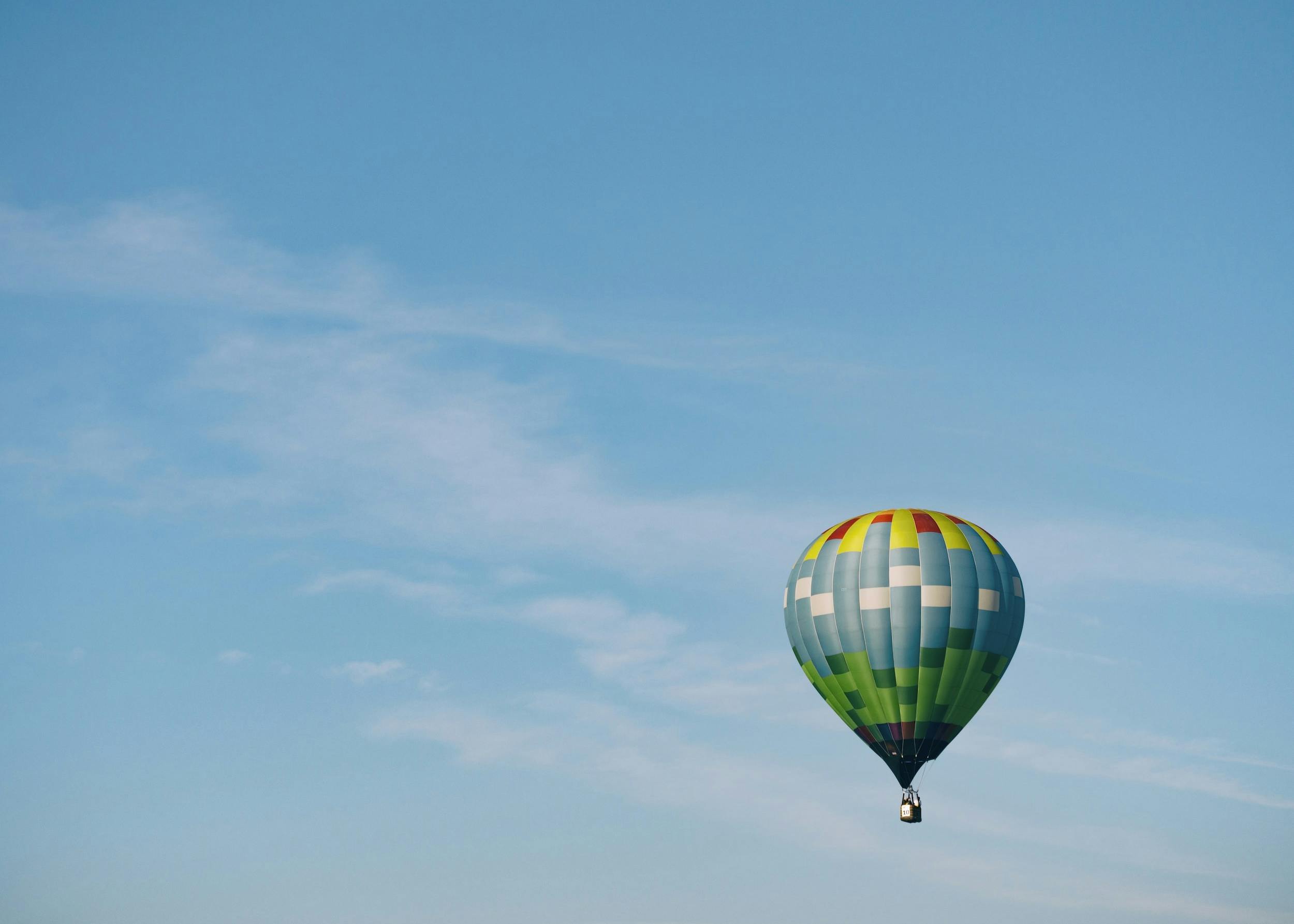 Prova multi-colored hot air balloon flying on sky