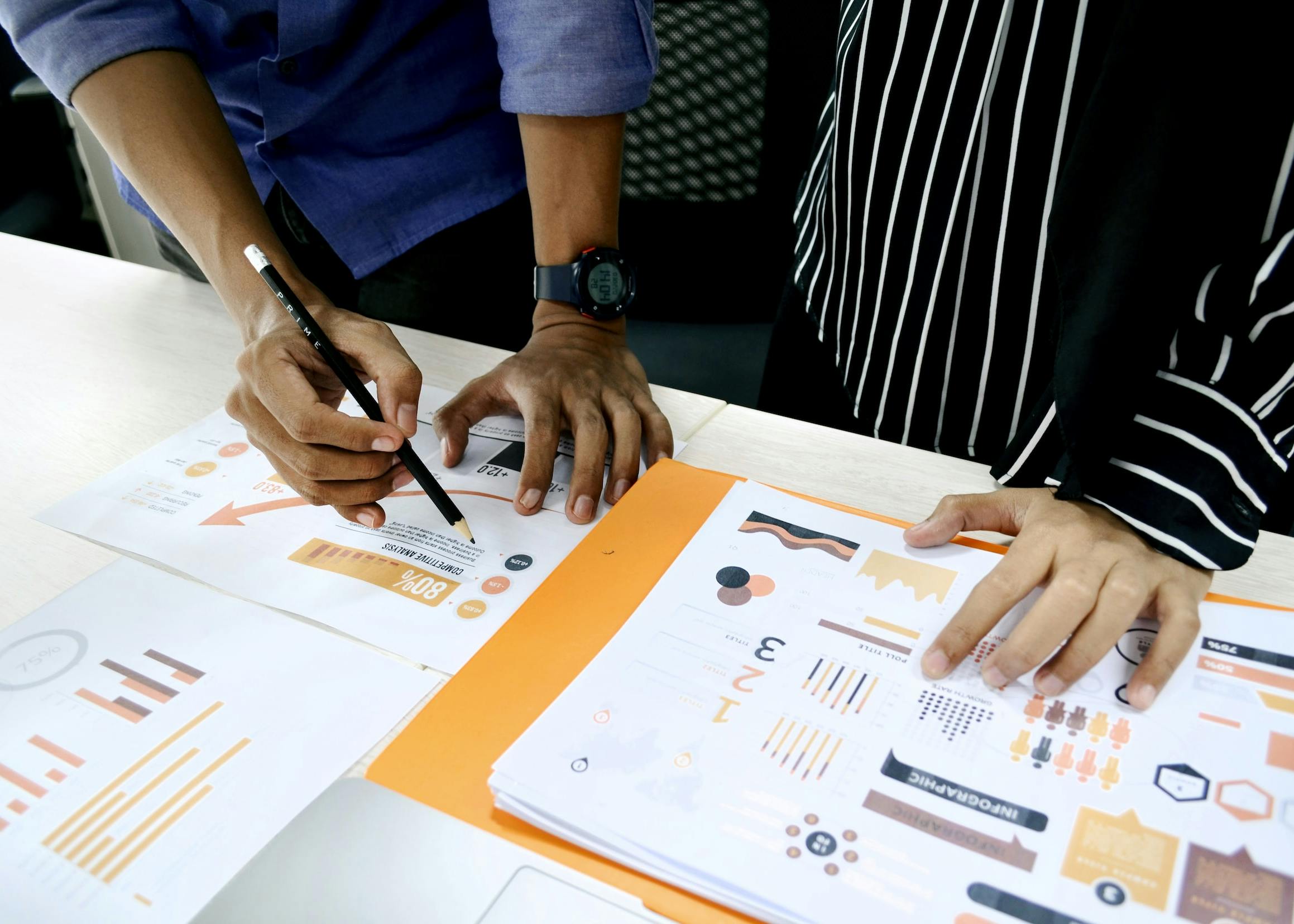Prova person in blue shirt writing on white paper