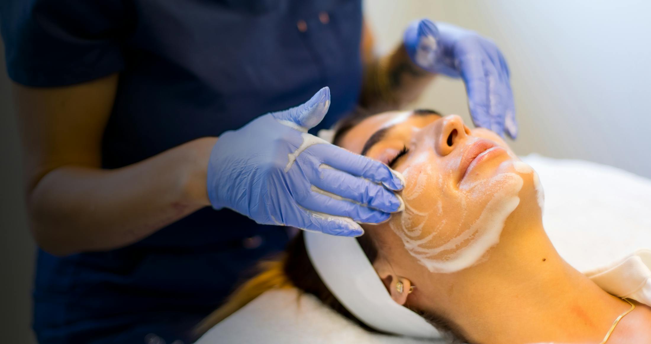 Female undering a facial procedure