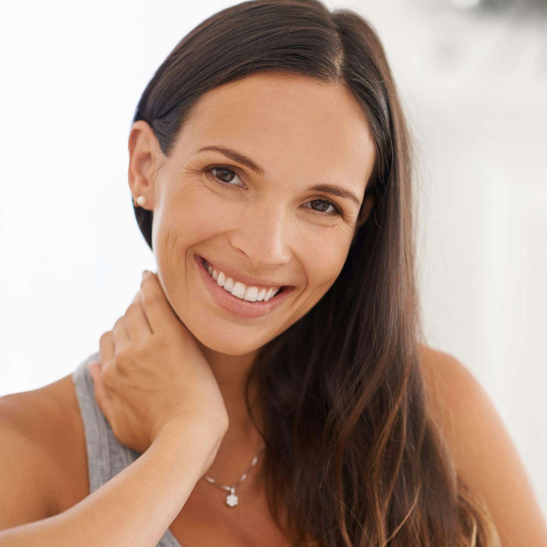 Closeup of a Woman with her Hand on her Neck
