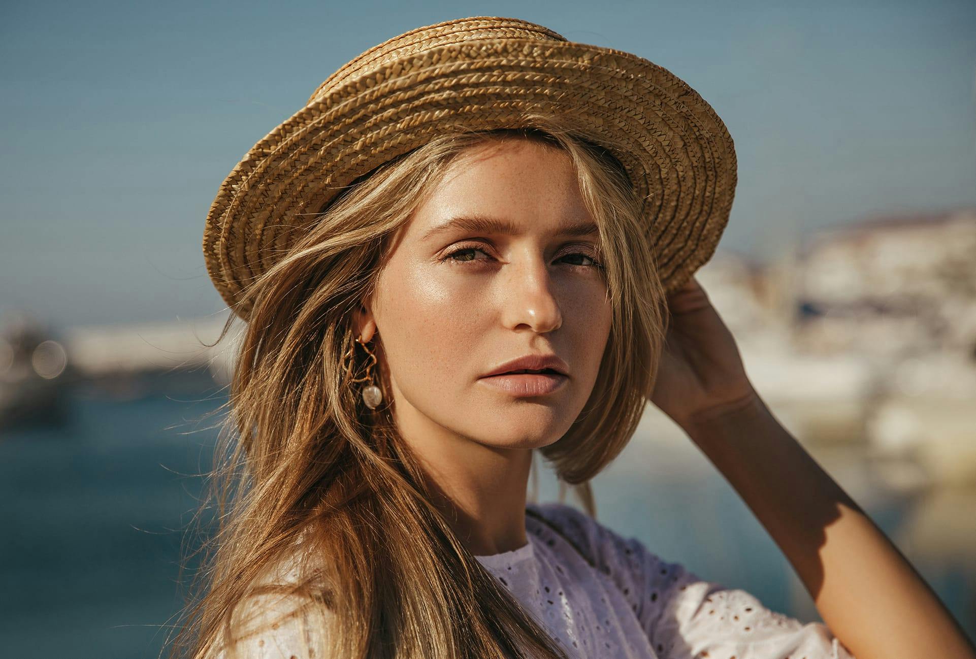 Woman with Straw Hat looking at the Camera