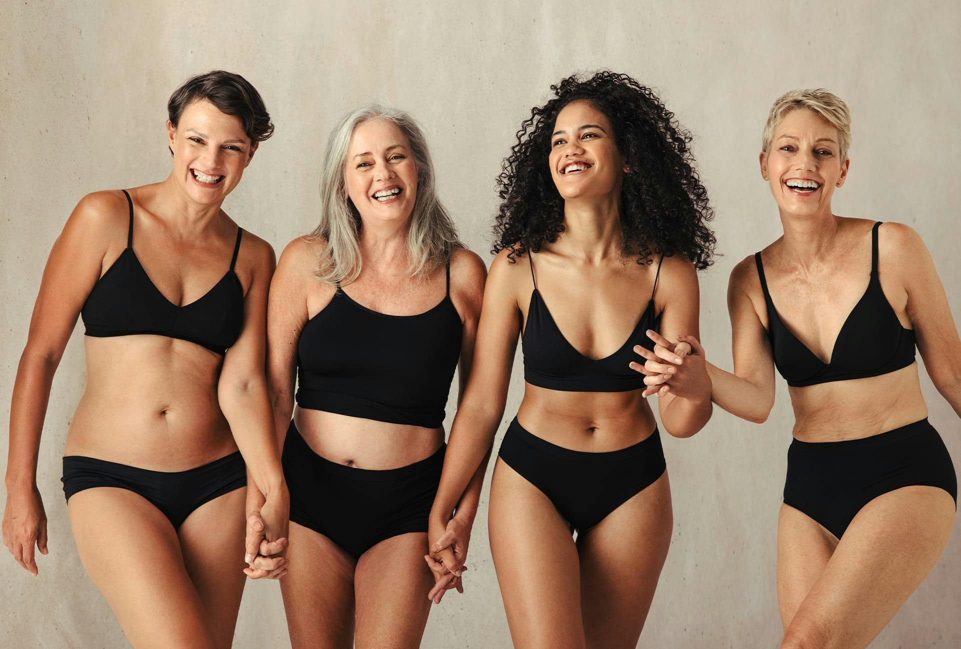 Group of Smiling Woman Wearing Black Under Garments