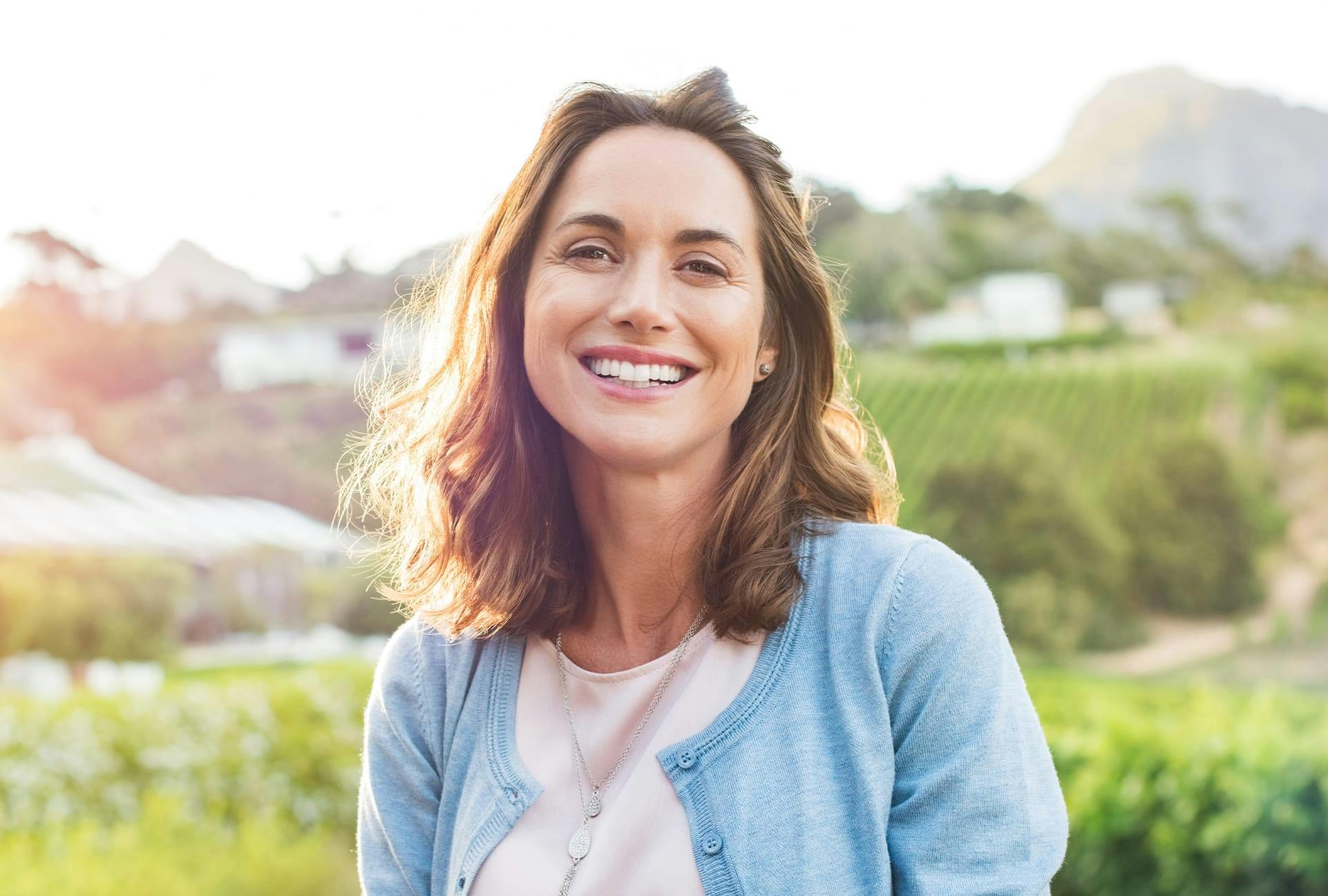 Smiling Woman with Blue Sweater