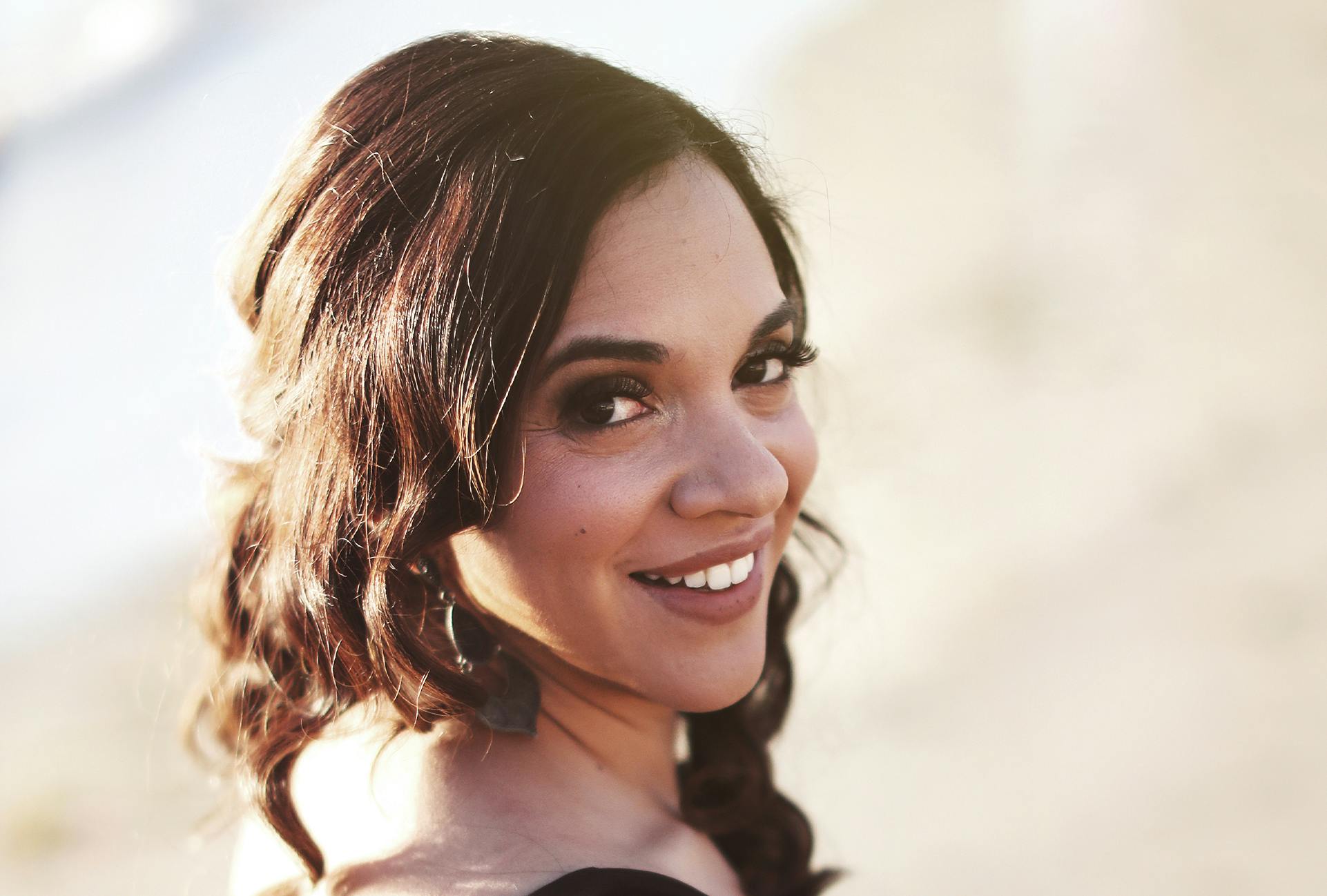 Woman with Dark Brown Hair Looking Back at the Camera