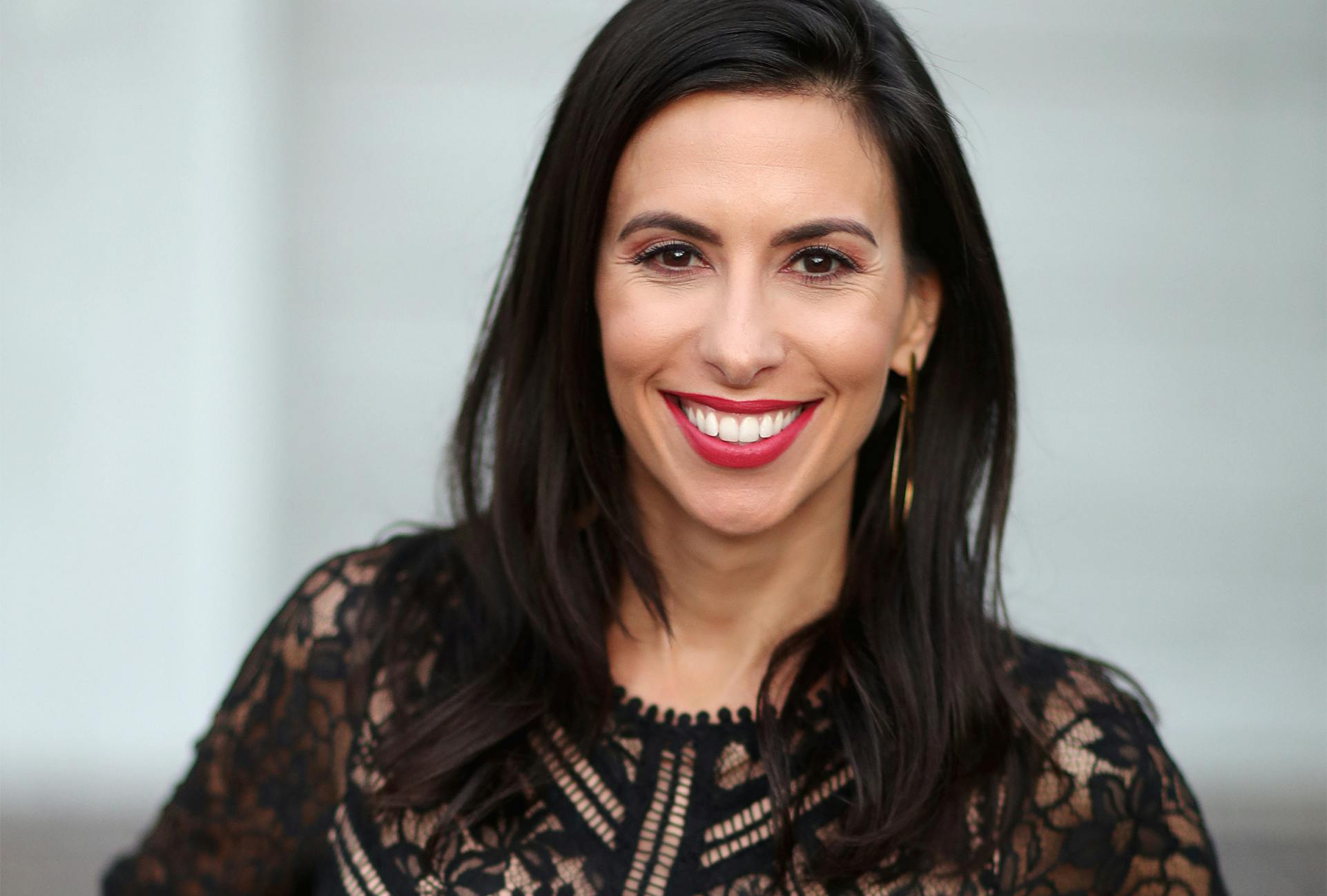 Smiling Woman with Dark Hair and Red Lipstick