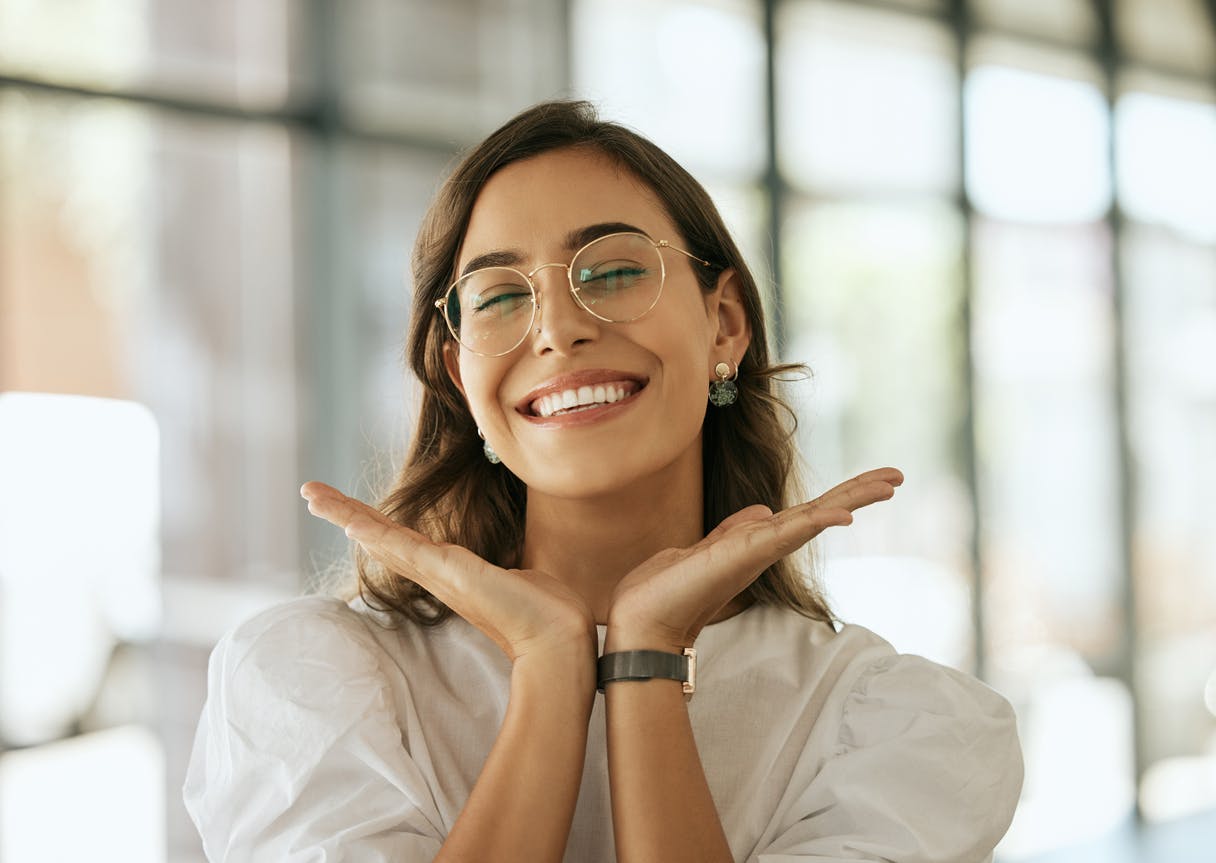 Woman with glasses smiling.