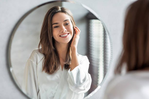 Woman Looking at Herself in the Mirror