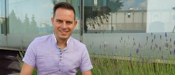 man sitting, flowers,