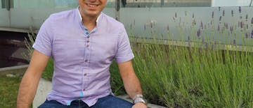 man sitting, flowers,