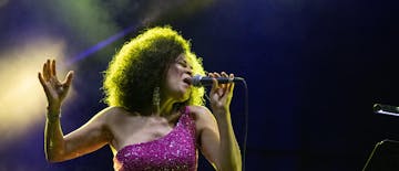 woman singing in violet dress