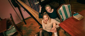 Two singers sitting on a floor