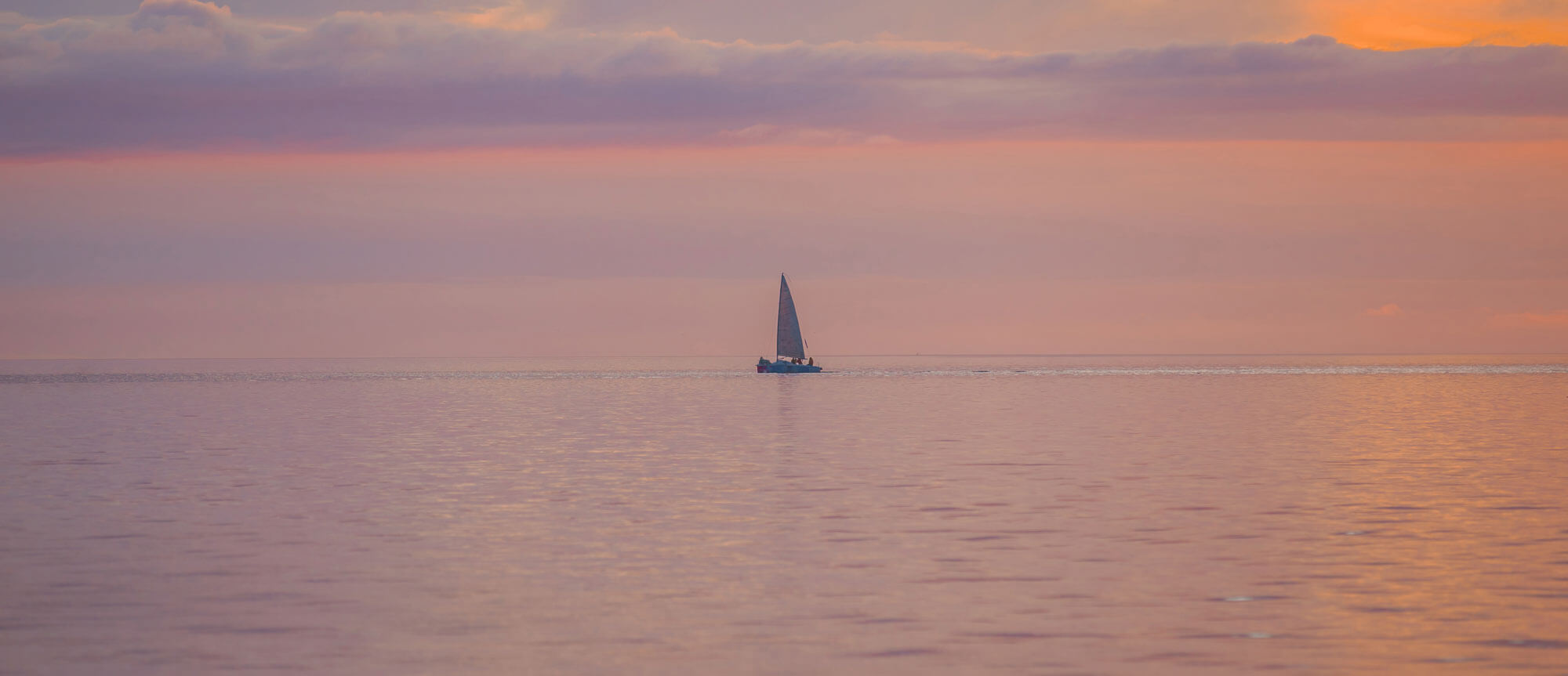 boat at sea at rosy sunset