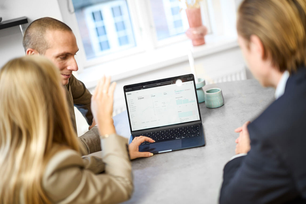 Aleta team looking at the Aleta platform