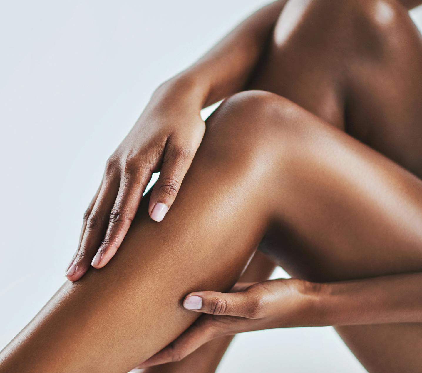 Woman touching her smooth legs